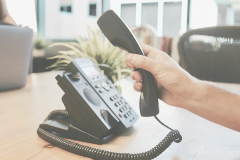 A team member handling a client inquiry about web design via phone.