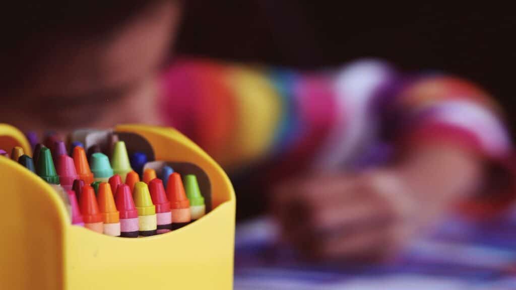 Colorful crayons in a yellow box with a blurred background, optimize image sizes for better web performance