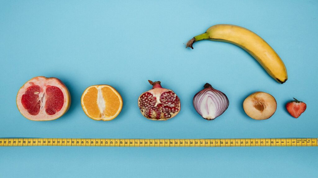 Long-tail keyword usage for fruit and vegetable size comparison with a measuring tape on a blue background