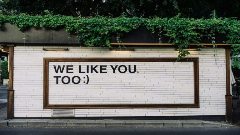 Secure socket layer message on a white brick wall with greenery above, promoting web design services in London.