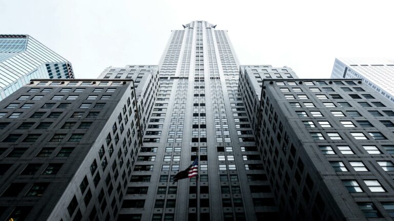 Target local customers with iconic New York skyscraper perspective showing American flag and Art Deco architecture