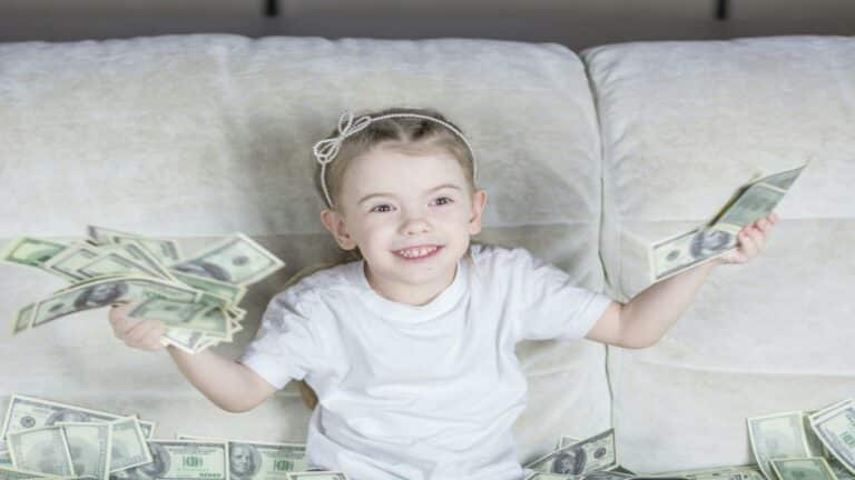 Website design company success represented by child with money showing digital business prosperity