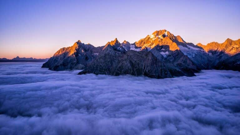 Local SEO services showcased through majestic mountain peaks emerging above cloud cover during golden hour, demonstrating peak performance and elevated digital presence