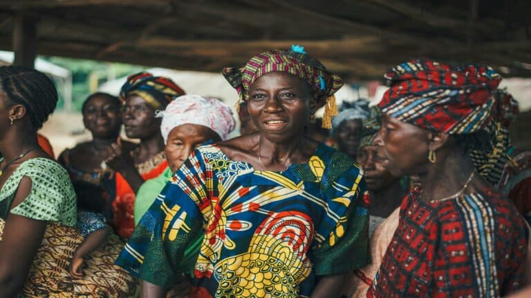 Group of women in colorful traditional clothing engaging in a community gathering to improve bounce rate.