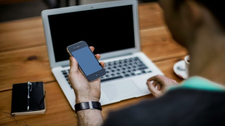 Person using a smartphone and laptop to improve user engagement