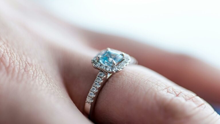 Create engaging content with a stunning engagement ring featuring a blue gemstone and diamond accents