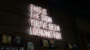 White neon sign on brick wall reading 'This is the sign you've been looking for' - perfect metaphor for search engine rankings