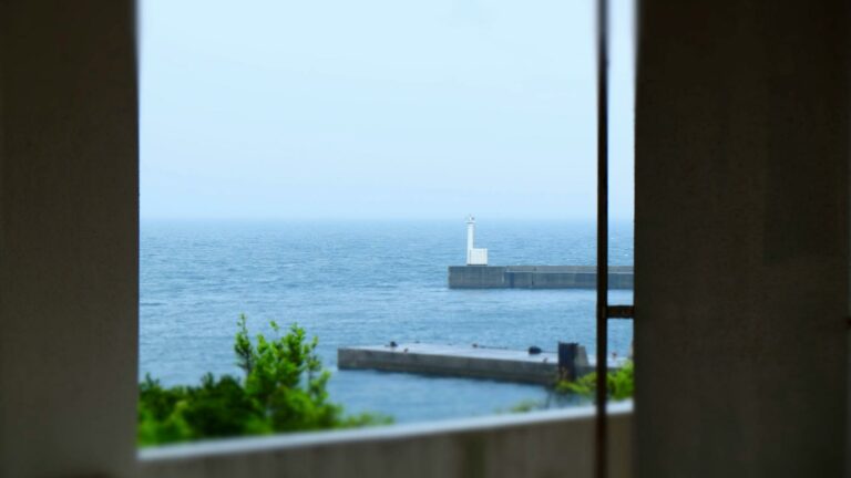 Lighthouse on a pier overlooking the sea, symbolizing guidance and strategy for online business growth.