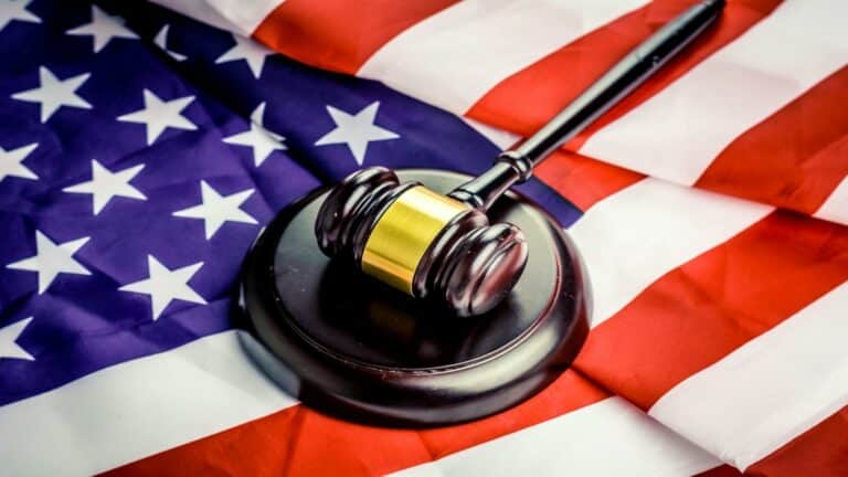 Website design company legal compliance gavel on American flag symbolizing digital law and regulations