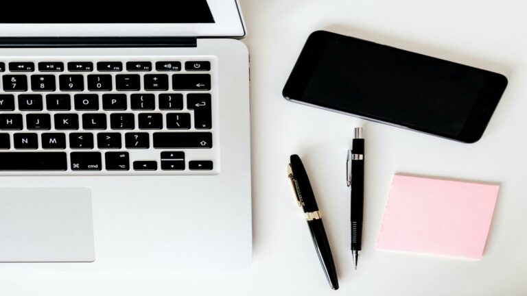 Laptop and smartphone setup showcasing responsive website design tools