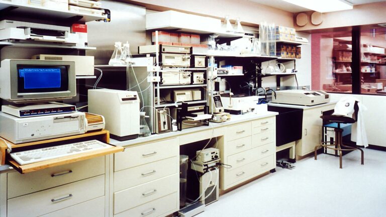 A laboratory setup with computers and analytical instruments.