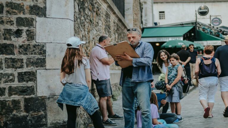 Mobile site optimization for outdoor training registration with instructor reviewing paperwork with students near pub entrance