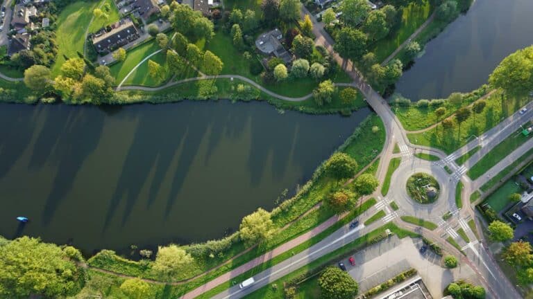 Aerial view of a roundabout near a waterway surrounded by greenery, showcasing elements of search engine marketing relevance.