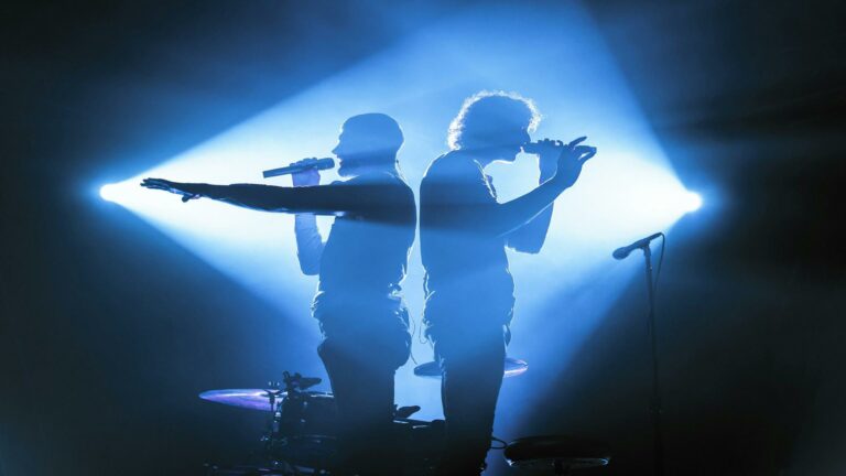 Silhouettes of two performers on stage representing digital marketing trends