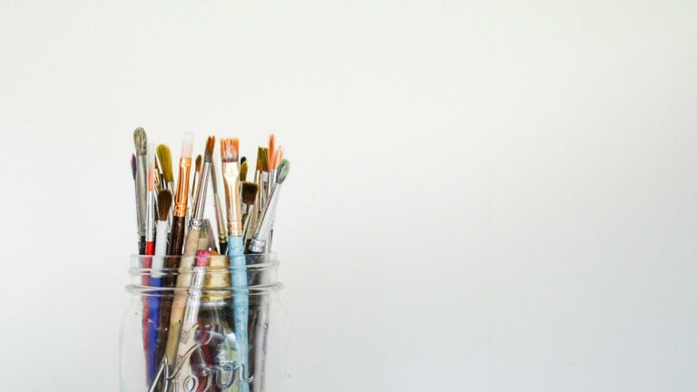 Professional paint brushes for search engine rankings optimization arranged in a clear mason jar against white background