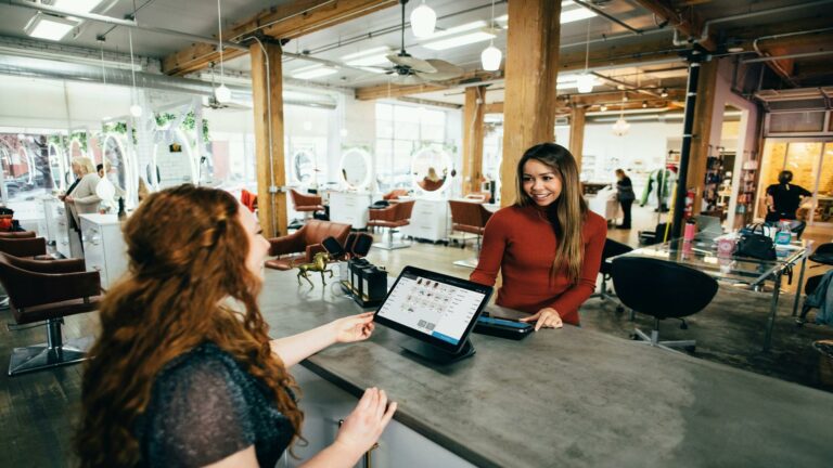 Salon interior showcasing digital checkout system and customer interaction