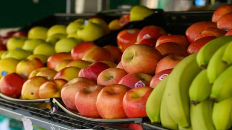 Assorted apples and bananas on display at a market