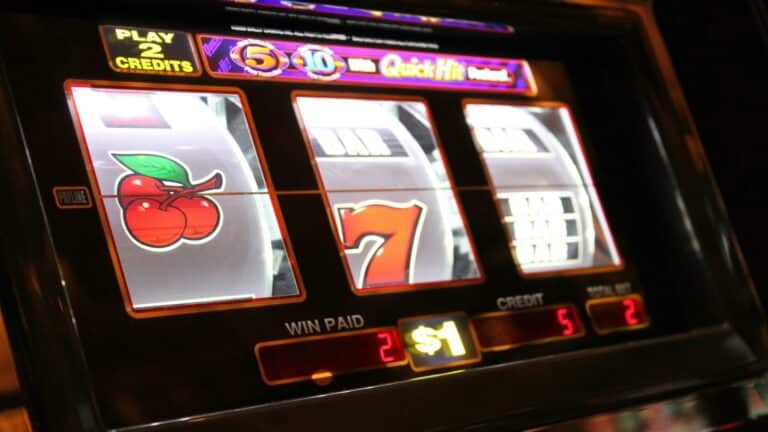 Close-up of a slot machine showing cherries and number seven