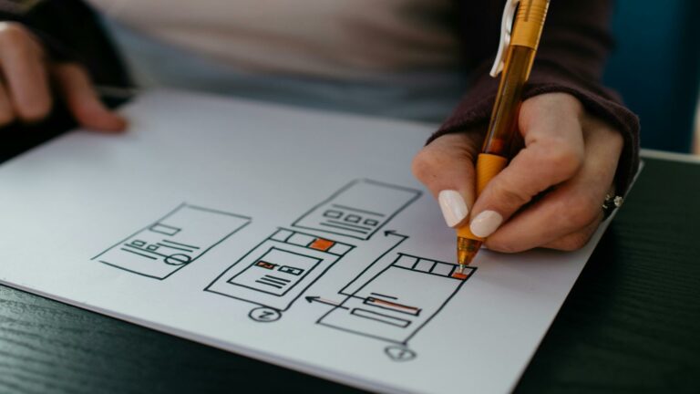 Person sketching search engine algorithms on paper