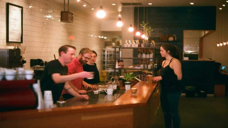 A team collaborating in a coffee shop showcasing business marketing strategies.