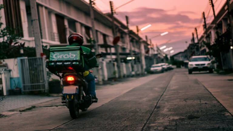 Delivery rider on a motorbike in a residential area at sunset to improve user engagement