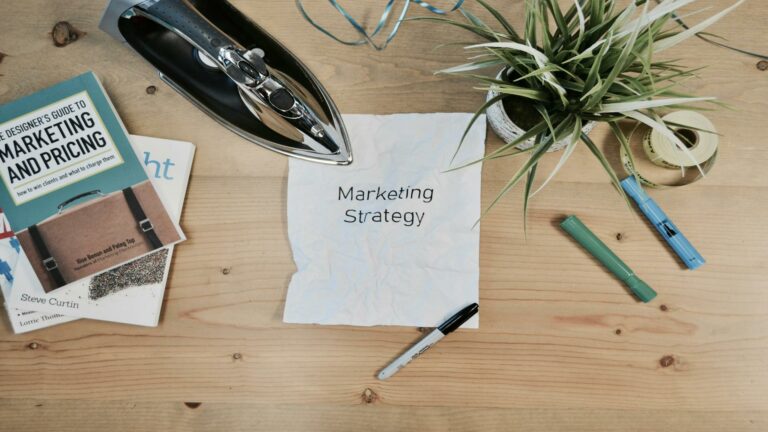 Desk with marketing strategy note, books, and office supplies