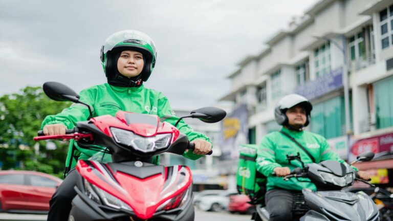 Grab riders on motorcycles in urban environment showcasing website user interface for delivery services