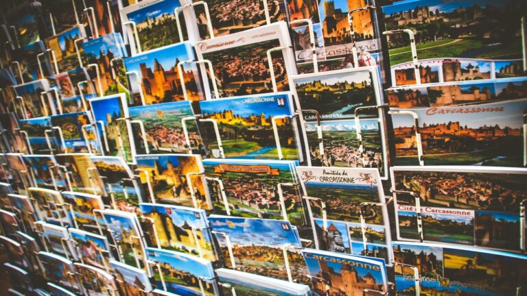 Postcards showcasing Carcassonne on a rack for long-tail keyword usage