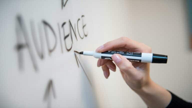 Website content ideas being written on whiteboard with dry erase marker showing content planning process