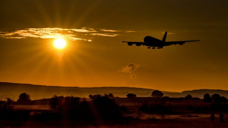 Airplane flying at sunset symbolizing high-quality backlinks for web design success