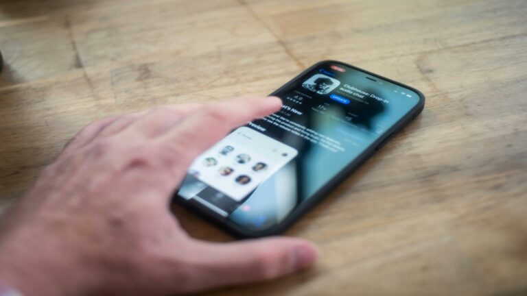 Hand interacting with a mobile app interface related to video content marketing