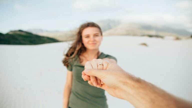 Person holding hands in a scenic desert landscape representing engaging content creation