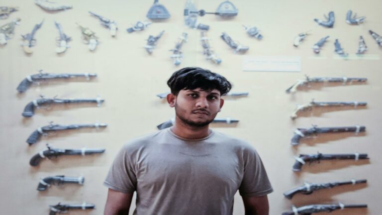 A man standing in front of a wall showcasing antique firearms, representing digital marketing strategies