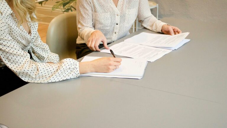 Two people reviewing documents at a table