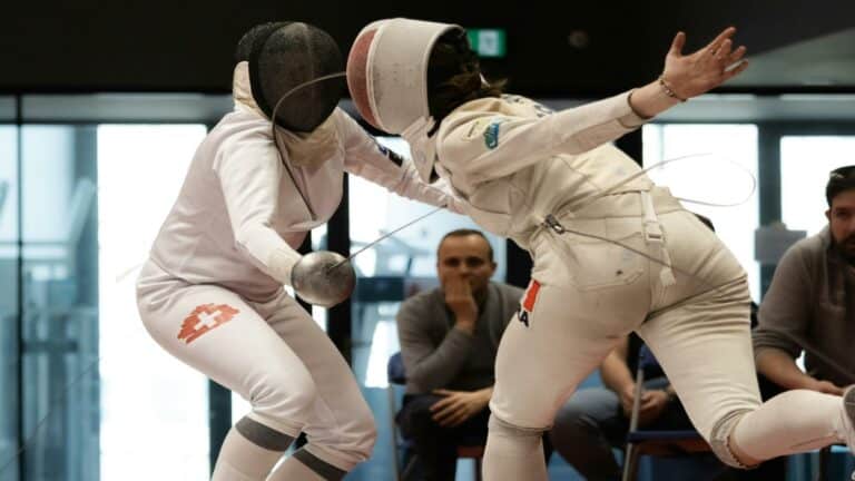 Two fencers engaged in a competitive duel showcasing long-tail keyword usage