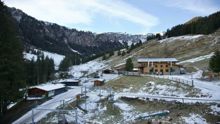 Snow-dusted alpine landscape with wooden lodges, a serene setting for online business growth inspiration