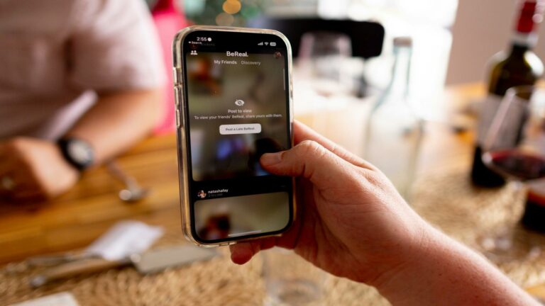 Hand holding a smartphone displaying the BeReal app interface, showcasing video content marketing potential