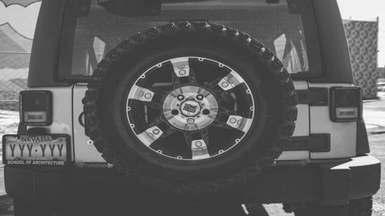 Close-up of a Jeep's spare tire with custom rim and Nevada license plate