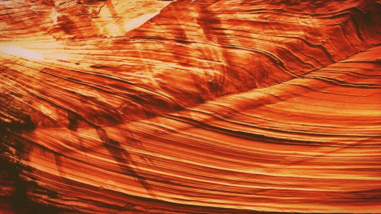 Close-up of layered sandstone with vibrant orange hues