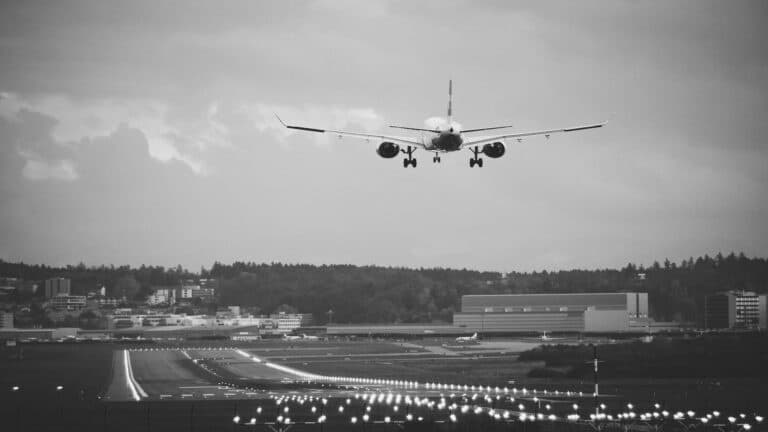 Airplane landing on a runway surrounded by cityscape, representing high-quality backlinks in digital marketing.