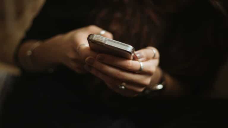 Close-up of a person using a smartphone, representing video content marketing