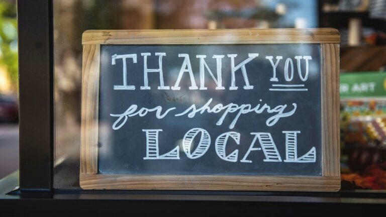 Chalkboard sign thanking customers for shopping local