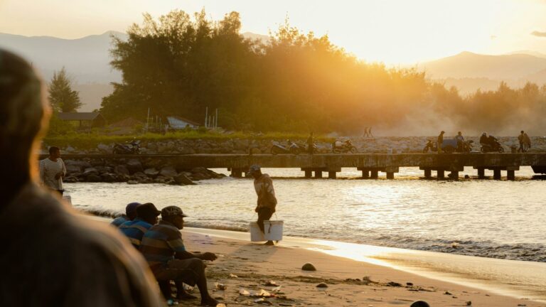 A serene sunset scene showcasing community interaction near a pier, emphasizing the importance of website usability testing for creating user-friendly online experiences.