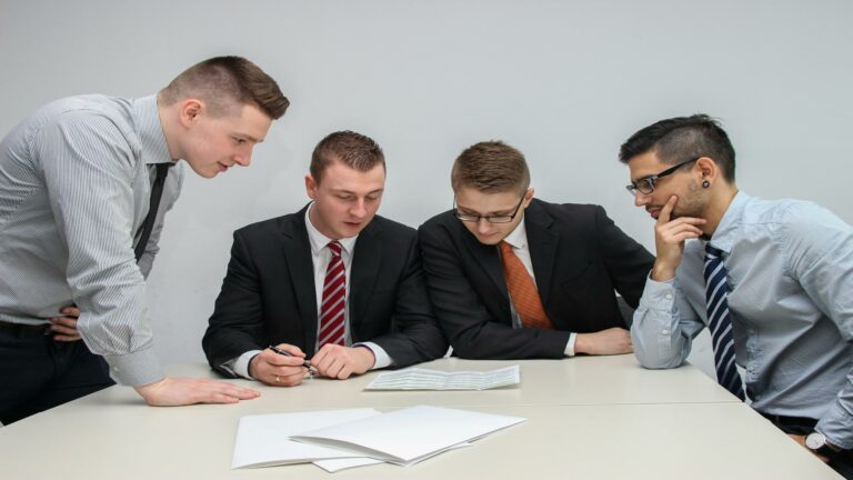 Group of professionals discussing documents at a table