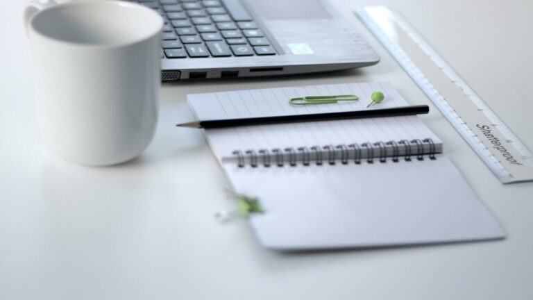 Minimalist desk setup with laptop, notepad, pencil, and coffee cup for SSL certificate installation