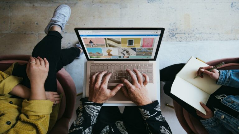 People working together with a laptop and notebook