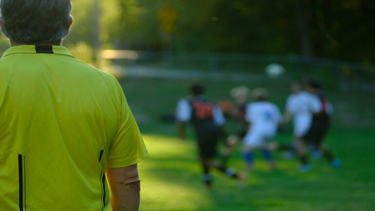 Website design company supervisor in yellow jersey overseeing team collaboration