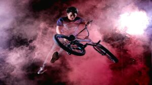 BMX rider performing a stunt in colorful smoke, ideal for local marketing campaigns