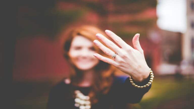 Hand showcasing a ring with a blurred background, symbolizing effective content strategy