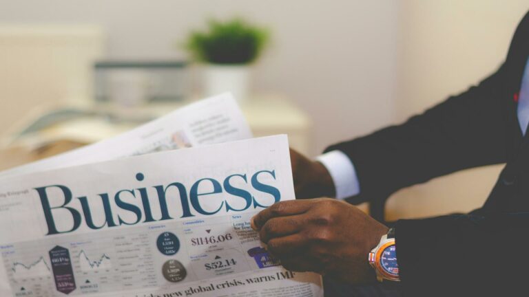 Businessman reading a business newspaper in London